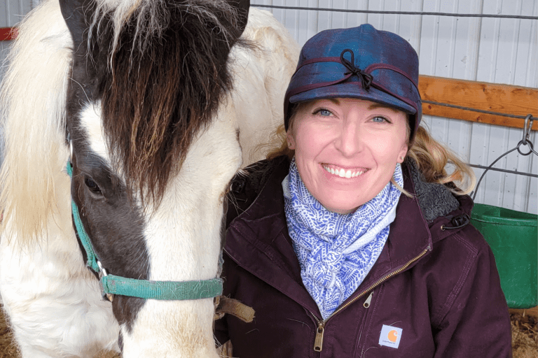 Dr. Rachel Shutter sitting with a horse.